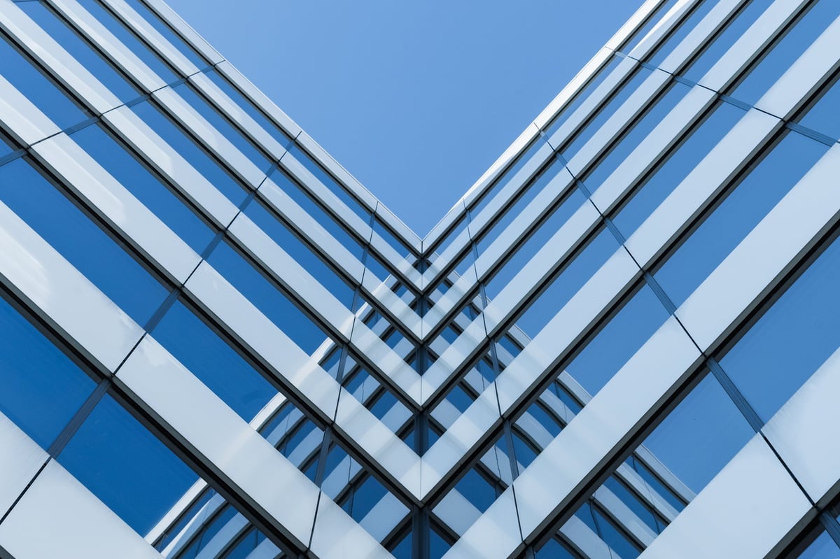 Symmetrical view of a modern glass building facade with strong geometric lines