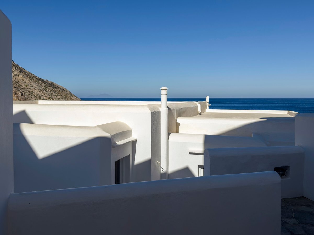 A coastal village with white Cycladic rooftops by the sea